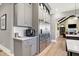 Kitchen with stainless steel refrigerator, gray cabinetry, and open floor plan at 3582 Pete Dye Blvd, Carmel, IN 46033