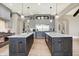 Modern kitchen featuring double islands, stainless steel appliances, and gray cabinets at 3582 Pete Dye Blvd, Carmel, IN 46033
