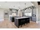 Bright kitchen with double islands, gray cabinets, stainless appliances, and hardwood floors at 3582 Pete Dye Blvd, Carmel, IN 46033