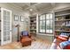Charming living room showcasing custom bookshelves, window with shutters and leather furniture at 3582 Pete Dye Blvd, Carmel, IN 46033