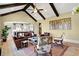 Open concept living room with vaulted ceiling, dark beams, and view into the kitchen at 3582 Pete Dye Blvd, Carmel, IN 46033