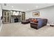 Basement Gathering room features a stone fireplace and plush leather seating, a cozy and inviting space at 3582 Pete Dye Blvd, Carmel, IN 46033