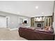 Basement living room with a fireplace, comfortable seating, and a wet bar area for entertaining guests at 3582 Pete Dye Blvd, Carmel, IN 46033