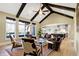 Open concept living area with vaulted ceilings, wood beams, and access to a patio at 3582 Pete Dye Blvd, Carmel, IN 46033