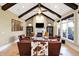Bright living room with a fireplace, vaulted ceilings, wood beams, and multiple windows at 3582 Pete Dye Blvd, Carmel, IN 46033