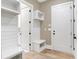 Functional mudroom with custom cabinets and shelving for organized storage near the home's entrance at 3582 Pete Dye Blvd, Carmel, IN 46033