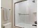 Modern shower and bath featuring subway tile and a glass door, showcasing a sleek and clean design at 3582 Pete Dye Blvd, Carmel, IN 46033