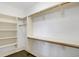 Well-organized walk-in closet with custom shelving and wood rods for ample storage solutions at 3582 Pete Dye Blvd, Carmel, IN 46033