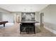 The gray wet bar includes a stone countertop, stylish backsplash, and seating at 3582 Pete Dye Blvd, Carmel, IN 46033