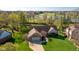 Aerial view features well-manicured lawns, mature trees, and a home with an attached garage at 4063 Millstream Rd, Greenwood, IN 46143