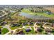 Community aerial view showcases mature trees, pond, golf course, and well-maintained homes at 4063 Millstream Rd, Greenwood, IN 46143