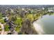 Aerial view showcasing lakefront homes with mature trees and lush green lawns at 4063 Millstream Rd, Greenwood, IN 46143