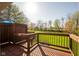 Wooden deck with views of large manicured backyard and lush trees in a park-like setting at 4063 Millstream Rd, Greenwood, IN 46143