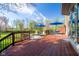 Expansive wooden deck with seating and shade umbrellas offers beautiful views of the manicured lawn and mature trees at 4063 Millstream Rd, Greenwood, IN 46143
