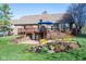 Spacious deck with a patio, landscaped garden and waterfall feature add to the beauty of this lovely backyard at 4063 Millstream Rd, Greenwood, IN 46143