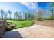 Brick patio and lush backyard with mature trees, landscaping, and a small waterfall feature offer a peaceful outdoor retreat at 4063 Millstream Rd, Greenwood, IN 46143