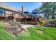 Beautifully landscaped backyard with a patio and multi-level deck with outdoor seating offers the perfect entertaining space at 4063 Millstream Rd, Greenwood, IN 46143