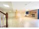 Finished basement space boasting wood floors, a charming fireplace, and staircase access for convenience at 4063 Millstream Rd, Greenwood, IN 46143