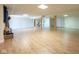 Basement offering fireplace, wood flooring, staircase access to the main floor, and overhead lighting at 4063 Millstream Rd, Greenwood, IN 46143