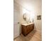 Bathroom vanity featuring round mirror, framed art, and light-colored walls at 4063 Millstream Rd, Greenwood, IN 46143