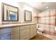 Bathroom with a double sink vanity, updated fixtures and a shower with striped curtain at 4063 Millstream Rd, Greenwood, IN 46143