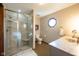 Bathroom with modern vanity, unique window, and glass enclosed shower with built in seating at 4063 Millstream Rd, Greenwood, IN 46143