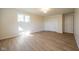 Well-lit bedroom featuring light-colored walls, wood-look flooring and a window at 4063 Millstream Rd, Greenwood, IN 46143