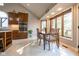 Sun-filled dining area with large bay windows, modern table, and views of the outdoor landscape at 4063 Millstream Rd, Greenwood, IN 46143