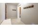 Hallway featuring tile flooring, neutral paint, a wood bench, and a coat rack for guests visiting this home at 4063 Millstream Rd, Greenwood, IN 46143