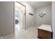 Hallway featuring tile flooring, neutral paint, a wood storage bench, and a coat rack with natural light at 4063 Millstream Rd, Greenwood, IN 46143
