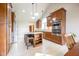 Bright kitchen with stainless steel appliances, a granite island with seating, and hardwood cabinets at 4063 Millstream Rd, Greenwood, IN 46143