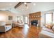 Cozy living room with hardwood floors, vaulted ceilings, a fireplace, and comfortable seating arrangement at 4063 Millstream Rd, Greenwood, IN 46143