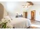 Bright bedroom with wood floors, vaulted ceiling, ceiling fan, and view to ensuite bathroom at 4063 Millstream Rd, Greenwood, IN 46143