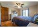 Main bedroom featuring a large window offering plenty of natural light and dark-stained hardwood floors at 4063 Millstream Rd, Greenwood, IN 46143