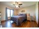 Main bedroom featuring a large window offering plenty of natural light and dark-stained hardwood floors at 4063 Millstream Rd, Greenwood, IN 46143