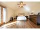 Bright main bedroom featuring hardwood floors, vaulted ceiling, ceiling fan, and French doors at 4063 Millstream Rd, Greenwood, IN 46143