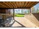 Spacious brick patio overlooks landscaped lawn with wooded view beyond at 4063 Millstream Rd, Greenwood, IN 46143