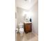 Bathroom featuring a modern vanity, sink, mirror, neutral paint, and a toilet with good natural light at 4063 Millstream Rd, Greenwood, IN 46143