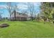 Large backyard featuring lush lawn, mature trees, fire pit, and a swing set for outdoor enjoyment at 4106 Armon Ct, Carmel, IN 46033
