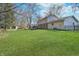 A spacious backyard showcasing a well-maintained lawn, storage shed, and a wooden swing set at 4106 Armon Ct, Carmel, IN 46033