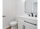 Modern powder room features white vanity with black accents at 4106 Armon Ct, Carmel, IN 46033