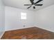 Well-lit bedroom featuring hardwood floors, a ceiling fan, and natural light from the window at 4106 Armon Ct, Carmel, IN 46033