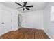 Bedroom with hardwood floors, white trim, ceiling fan, and two closets for storage at 4106 Armon Ct, Carmel, IN 46033