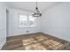 Bright dining room with modern chandelier, wood-style floors and large window at 4106 Armon Ct, Carmel, IN 46033
