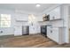 Modern kitchen with stainless steel appliances, white cabinets, and subway tile backsplash at 4106 Armon Ct, Carmel, IN 46033