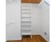 Spacious walk-in closet with custom white shelving and hardwood floors for ample storage at 4106 Armon Ct, Carmel, IN 46033