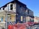 Severe fire damage to the home including missing siding, broken windows, and charred remains at 432 N Hamilton Ave, Indianapolis, IN 46201