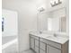 Bathroom featuring double sinks, quartz countertops, and modern lighting fixtures at 4327 Persian St, Greenwood, IN 46143