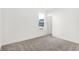 Bright room with big window, gray carpet, and exterior view at 4327 Persian St, Greenwood, IN 46143