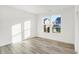 Bright bedroom with hardwood floors and a large window offering views of the neighborhood at 4327 Persian St, Greenwood, IN 46143